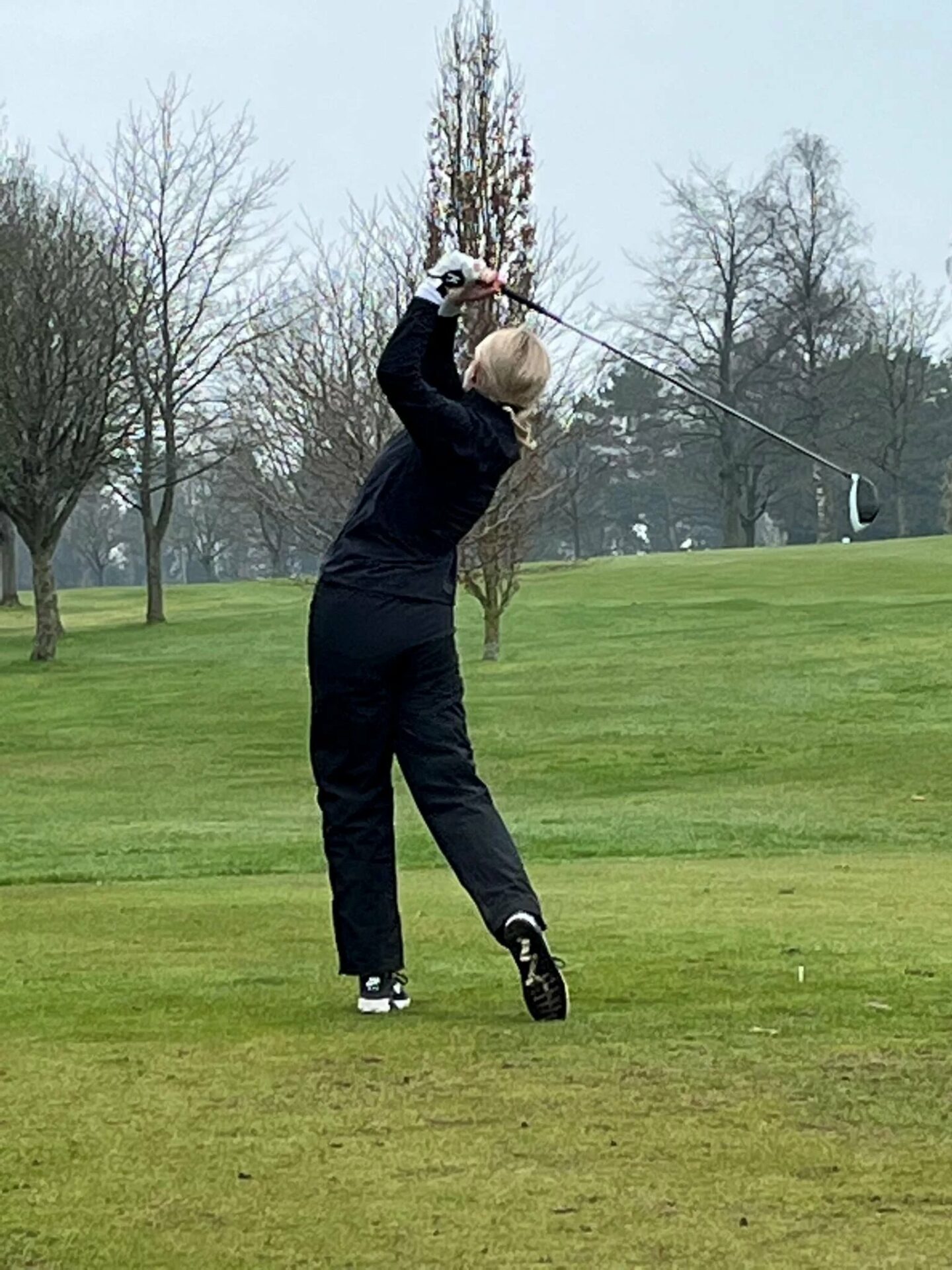 Photo of a woman playing golf.